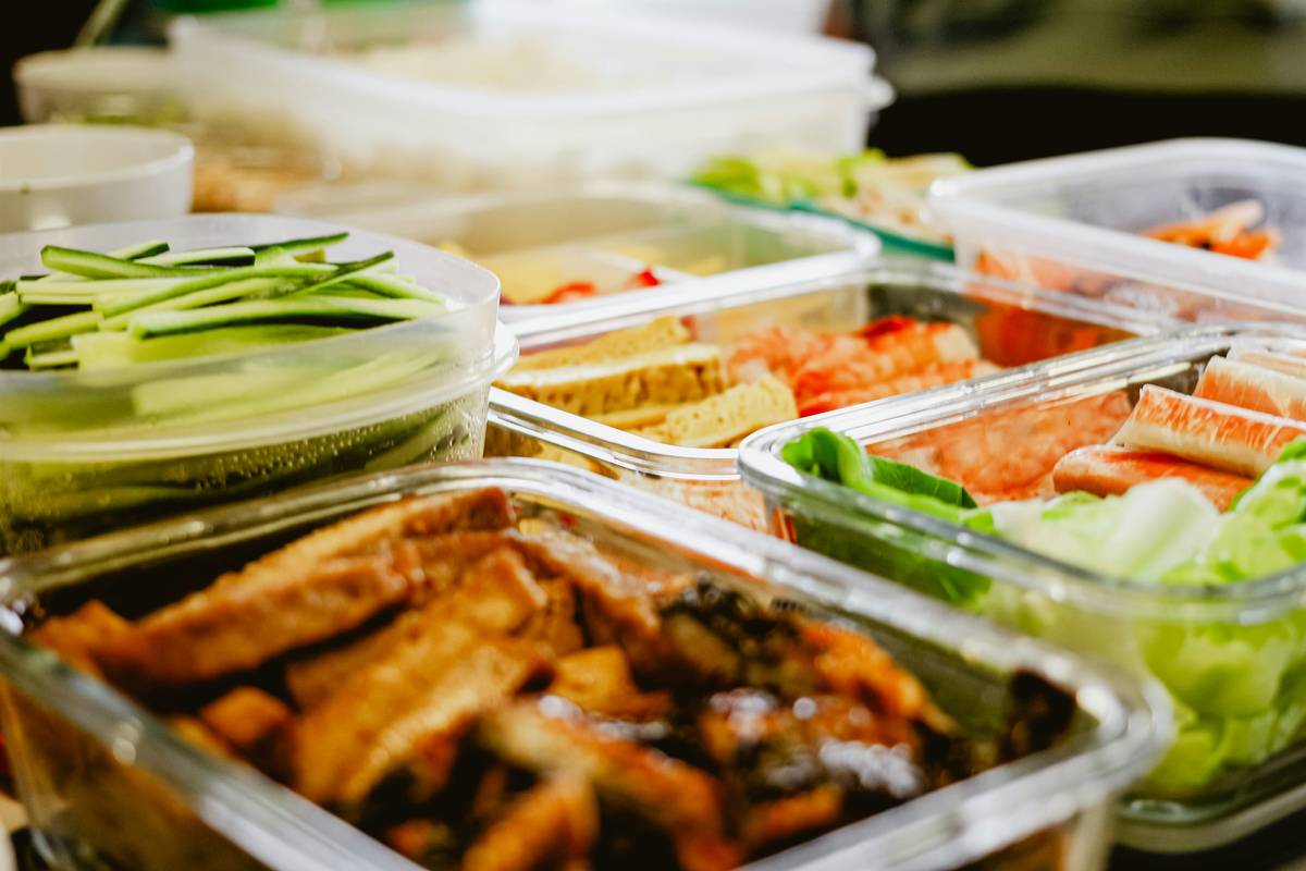 Colorful frozen meal components organized for weekly lunch plan assembly
